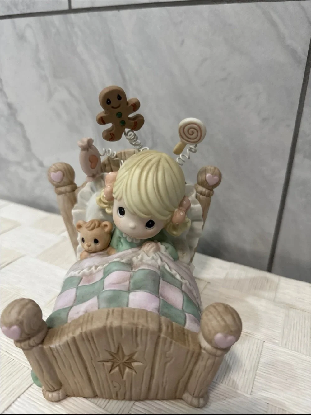 Precious Moments Blonde Girl Figurine with Pastel Pink & Mint Quilt